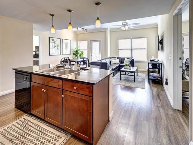 Kitchen island dishwasher sink couch coffee table living room at The Block on 28th in Austin Student Accommodation