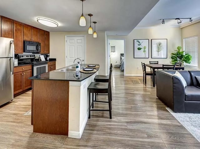 Modern kitchen island dining area living room apartment at The Block on 28th in Austin Student Accommodation