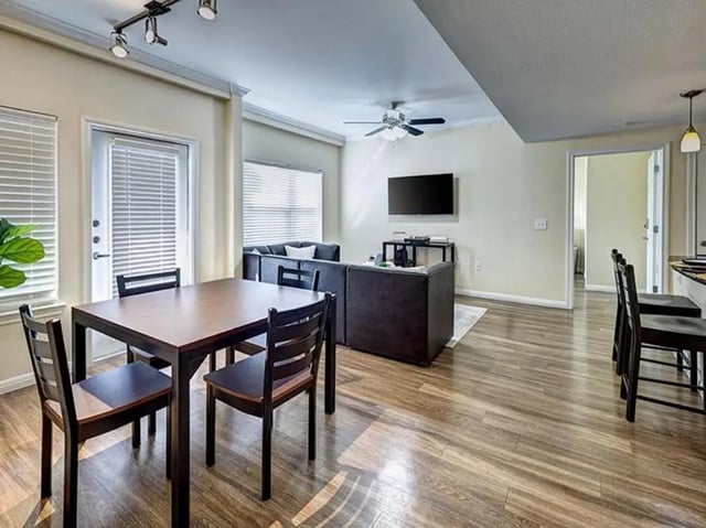 Dining table, sofa, TV, and chairs Living Room at The Block on 28th in Austin Student Accommodation