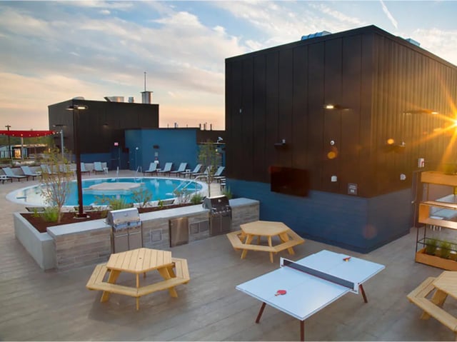 Grill picnic tables ping pong table pool exterior at The James in Madison Student Accommodation