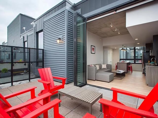 Red chairs on patio with living room kitchen exterior at The James in Madison Student Accommodation