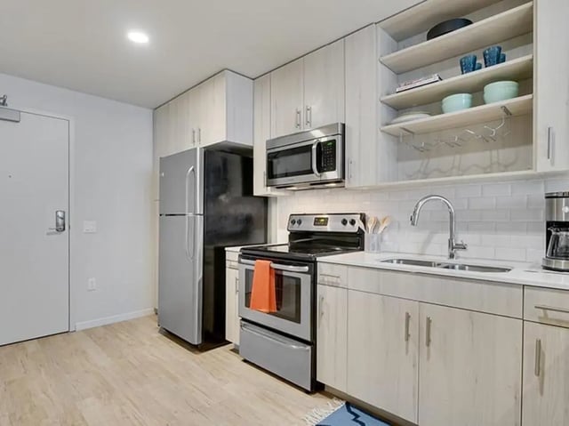 Fridge stove microwave sink cabinets kitchen at The James in Madison Student Accommodation
