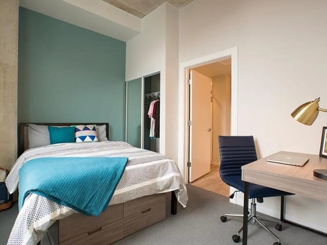 Bed desk chair closet door bedroom at The James in Madison Student Accommodation