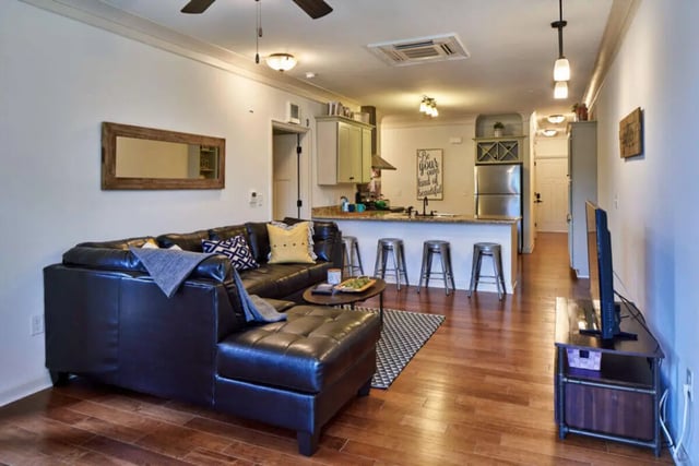 L-shaped leather couch kitchen island living room at Arcadia Student Living in Charlotte Student Accommodation