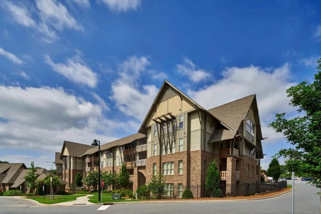 Apartment building with balconies and pitched roofs exterior at Arcadia Student Living in Charlotte Student Accommodation