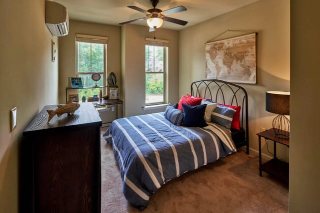 Bed dresser desk and world map bedroom at Arcadia Student Living in Charlotte Student Accommodation