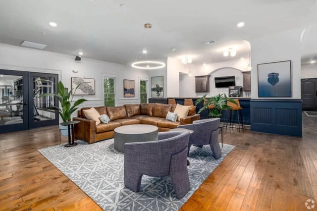 Brown leather sectional sofa bar area lounge area at Arcadia Student Living in Charlotte Student Accommodation