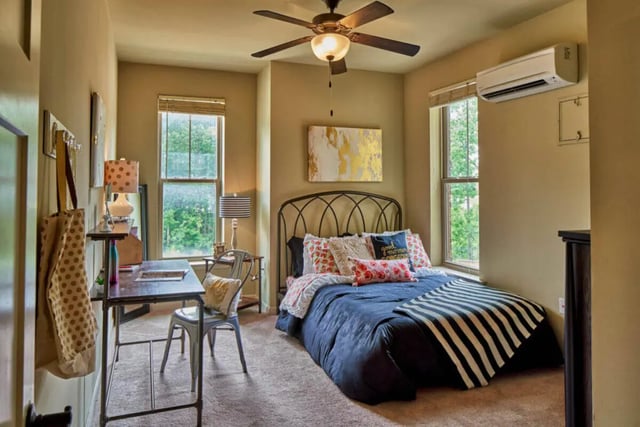 Bed desk chair window air conditioner bedroom at Arcadia Student Living in Charlotte Student Accommodation