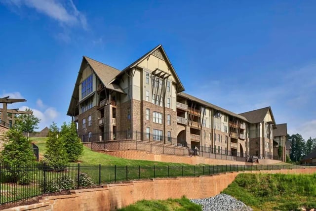 Apartment building with balconies and brick exterior exterior at Arcadia Student Living in Charlotte Student Accommodation