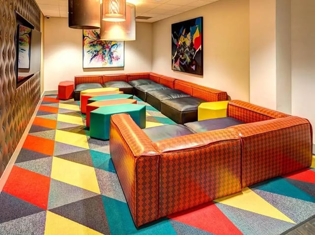 Sectional sofa colorful stools modern art living room at University Crossings in Philadelphia Student Accommodation