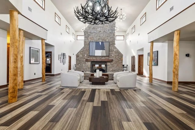 Stone fireplace armchairs coffee table living room at Montara Park in Norman Student Accommodation