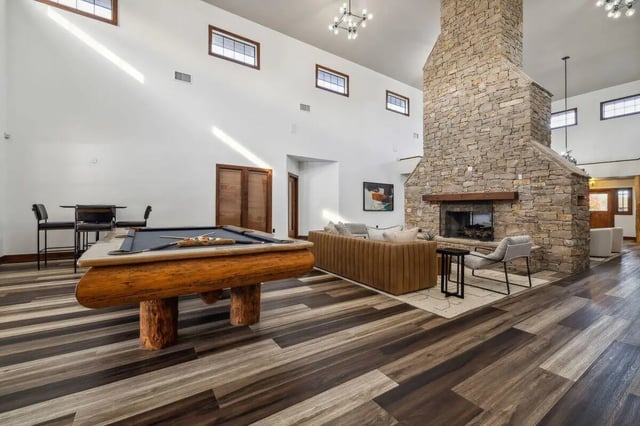Pool table bar stools fireplace and living area common room at Montara Park in Norman Student Accommodation