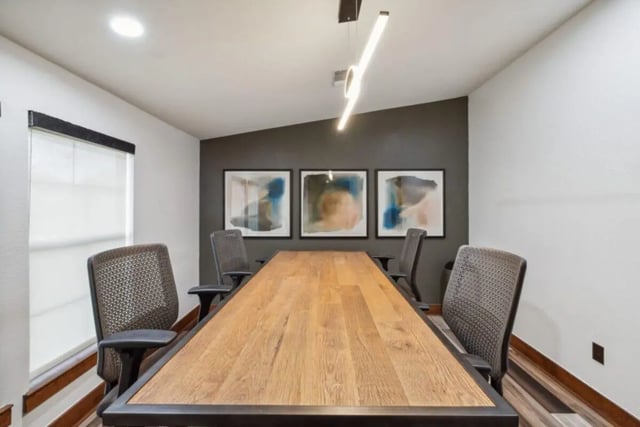 Wooden table chairs artwork modern light fixture study area at Montara Park in Norman Student Accommodation