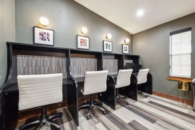 Four white chairs and laptops study area at Montara Park in Norman Student Accommodation