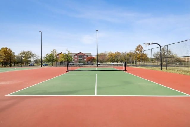 Tennis court with basketball hoop playing area at Montara Park in Norman Student Accommodation
