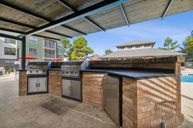 Two grills and refrigerator exterior kitchen area at Montara Park in Norman Student Accommodation