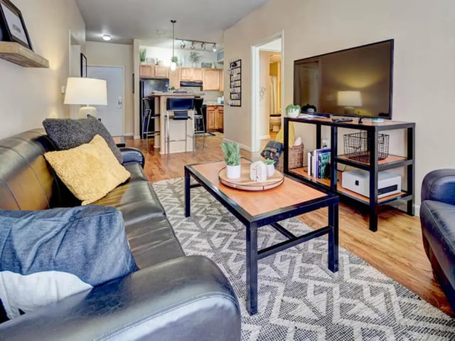 Leather sofa coffee table and TV living room at Union in Waco Student Accommodation