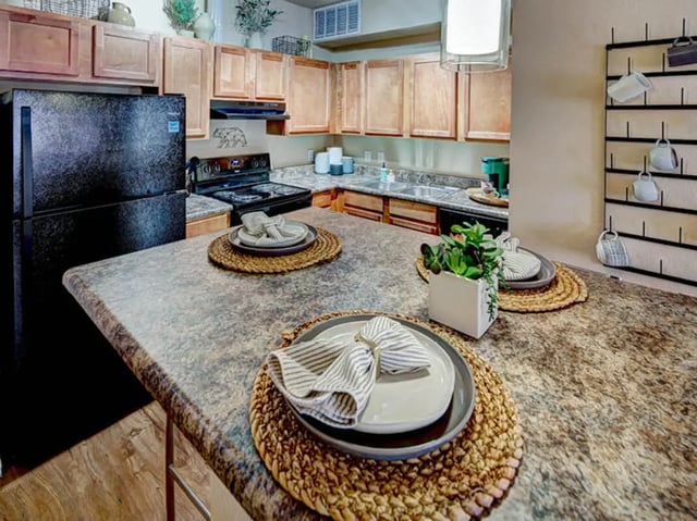 Countertop plates plant microwave oven kitchen at Union in Waco Student Accommodation