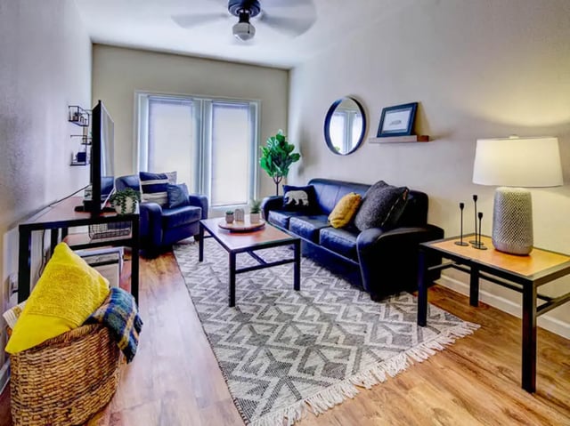 Black sofa coffee table rug living room at Union in Waco Student Accommodation