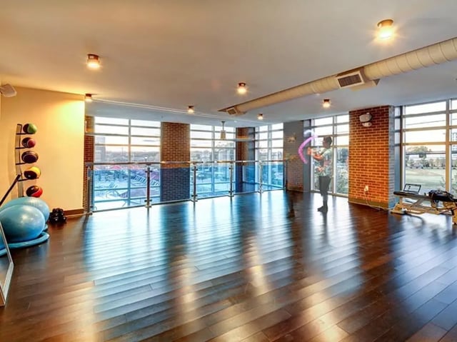 Exercise balls weights and a person playing gym at University Crossings Charlotte in Charlotte Student Accommodation