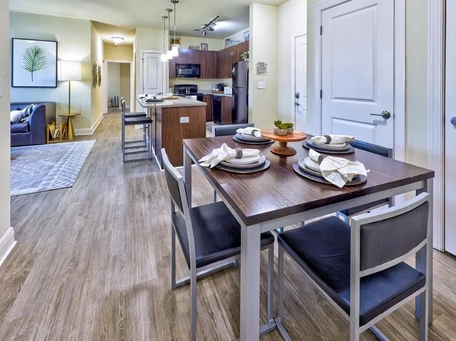 Dining table with place settings kitchen counter living room at University Crossings Charlotte in Charlotte Student Accommodation