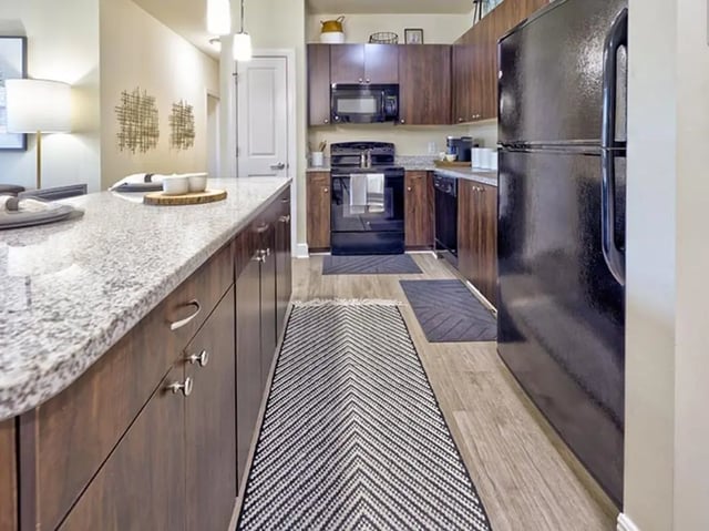 Kitchen island cabinets oven refrigerator rug kitchen at University Crossings Charlotte in Charlotte Student Accommodation