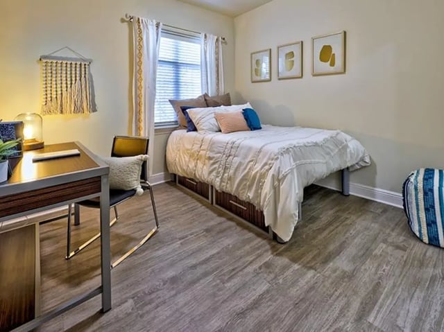 Bed desk chair artwork window blinds bedroom at University Crossings Charlotte in Charlotte Student Accommodation
