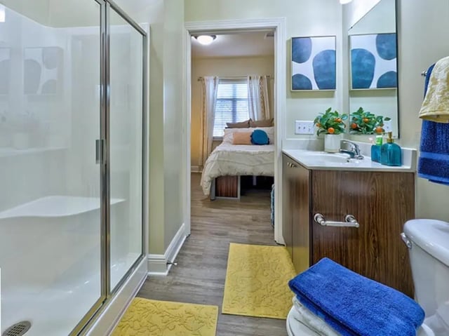 Shower vanity with toilet bedroom beyond bathroom at University Crossings Charlotte in Charlotte Student Accommodation