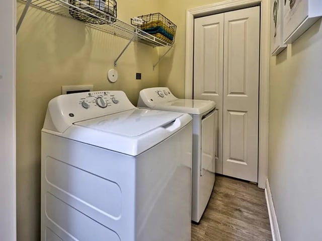Two white washing machines with wire shelf laundry area at University Crossings Charlotte in Charlotte Student Accommodation