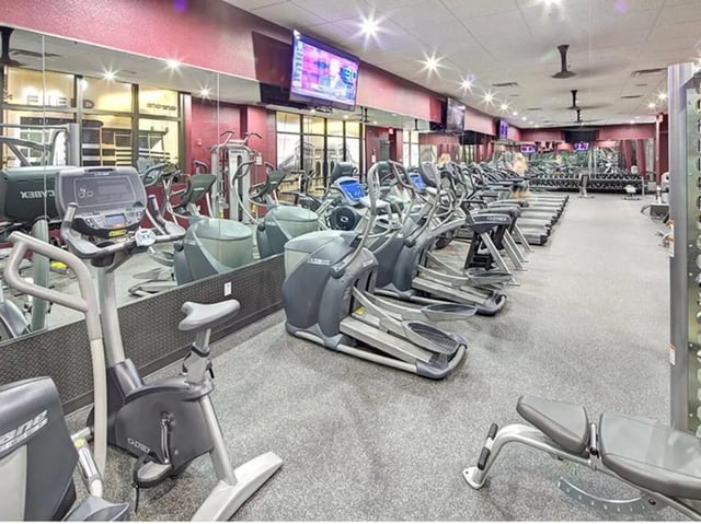 Gym equipment elliptical bikes treadmills weight bench Fitness area at The Callaway House in College Station Student Accommodation