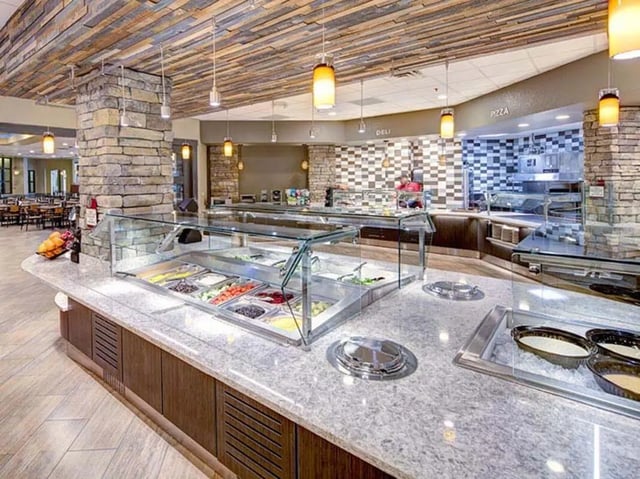 Salad bar with food and deli counter dining area at The Callaway House in College Station Student Accommodation