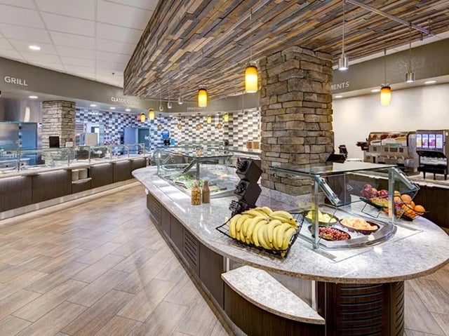 Buffet line with fruit and salads cafeteria at The Callaway House in College Station Student Accommodation