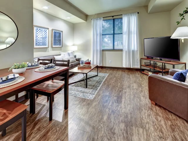 Dining table couch TV rug living room at The Callaway House in College Station Student Accommodation