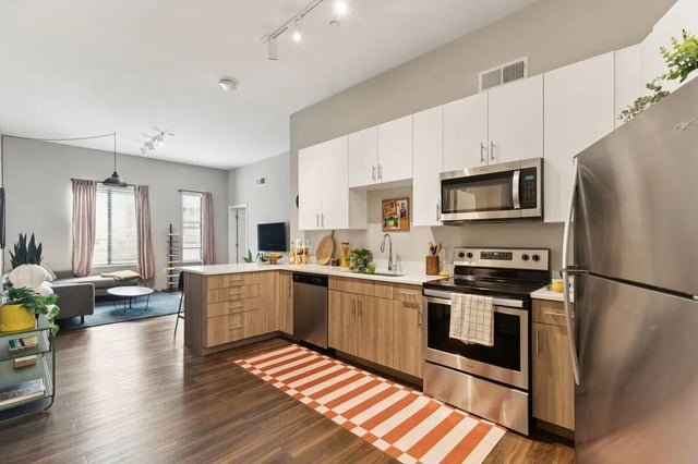 Modern kitchen with appliances and living area Living room at Paloma University City in Philadelphia Student Accommodation