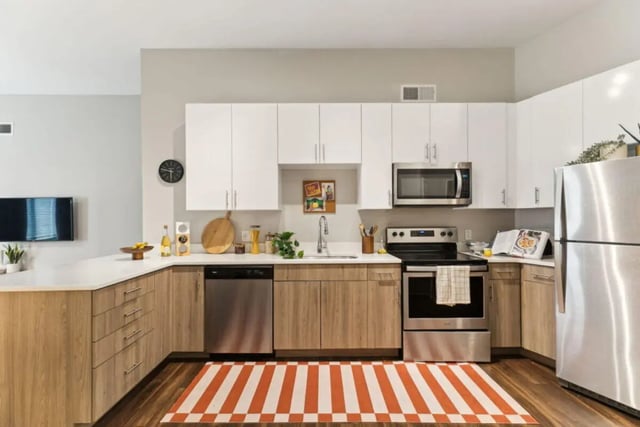 Modern kitchen with stainless steel appliances and white cabinets kitchen at Paloma University City in Philadelphia Student Accommodation