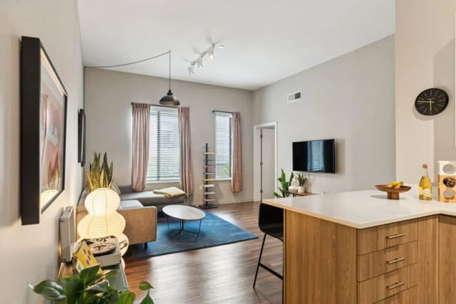 Sofa coffee table television kitchen island living room at Paloma University City in Philadelphia Student Accommodation