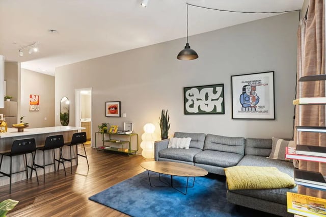 Gray sectional couch oval coffee table living room at Paloma University City in Philadelphia Student Accommodation