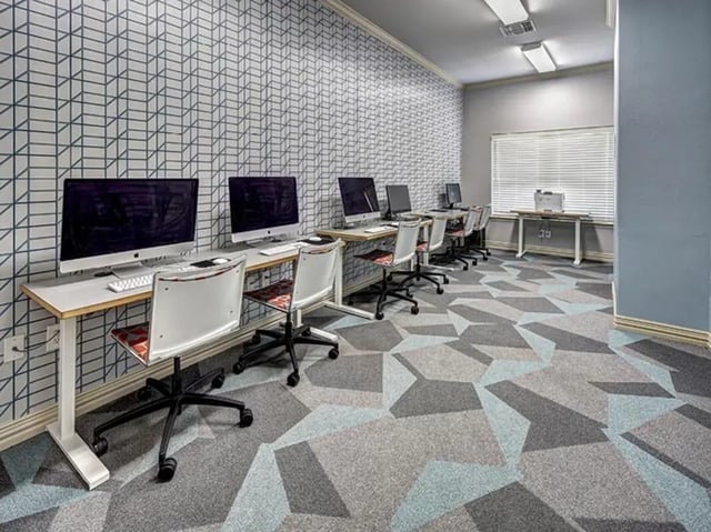Computers and chairs in a study area at University Trails in Lubbock Student Accommodation