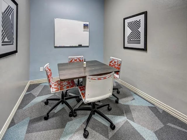 Square table four chairs whiteboard study area at University Trails in Lubbock Student Accommodation