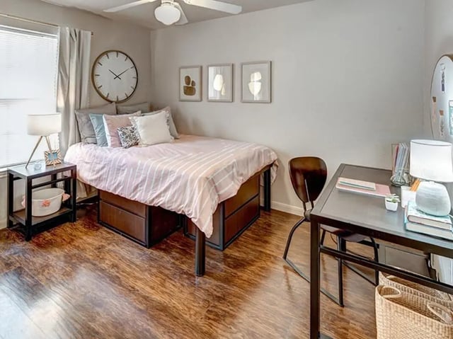 Bed desk lamp and basket bedroom at University Trails in Lubbock Student Accommodation