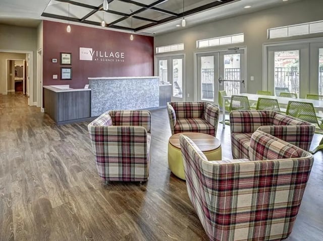 Plaid chairs reception desk communal area at The Village At Science Drive in Orlando Student Accommodation
