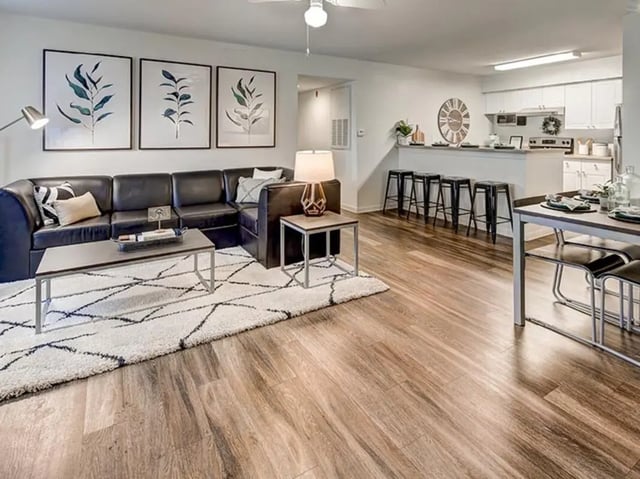 sectional couch coffee table artwork kitchen living area at The Village At Science Drive in Orlando Student Accommodation