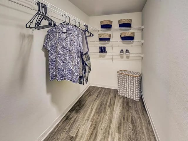 Clothes on hangers baskets shoes laundry hamper closet at The Village At Science Drive in Orlando Student Accommodation