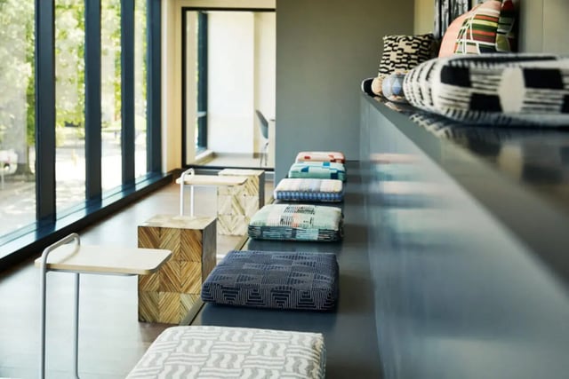 Patterned cushions and side tables lounge area at Seven07 in Champaign Student Accommodation