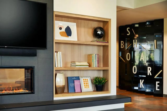 Bookshelf fireplace and television living room at Seven07 in Champaign Student Accommodation