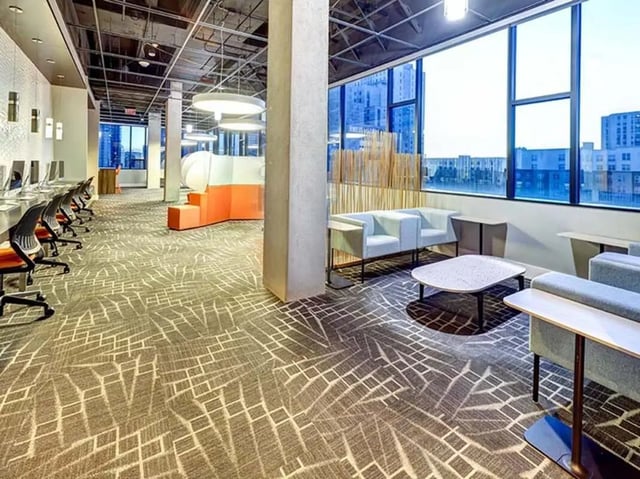 Modern lounge area with computers and seating living area at The Castilian in Austin Student Accommodation