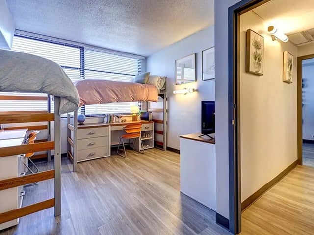 Bunk beds desks and chairs student room at The Castilian in Austin Student Accommodation