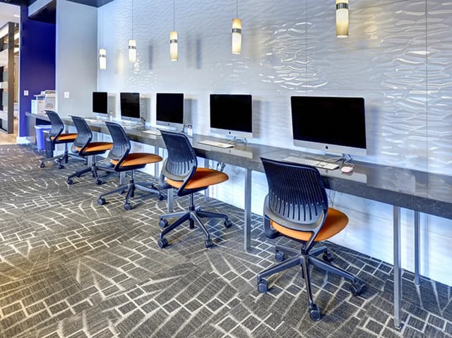 Computers and chairs in a communal study area at The Castilian in Austin Student Accommodation