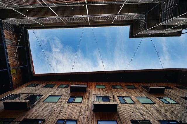 Wooden building exterior with balconies and sky. Exterior at Park East in Springfield Student Accommodation