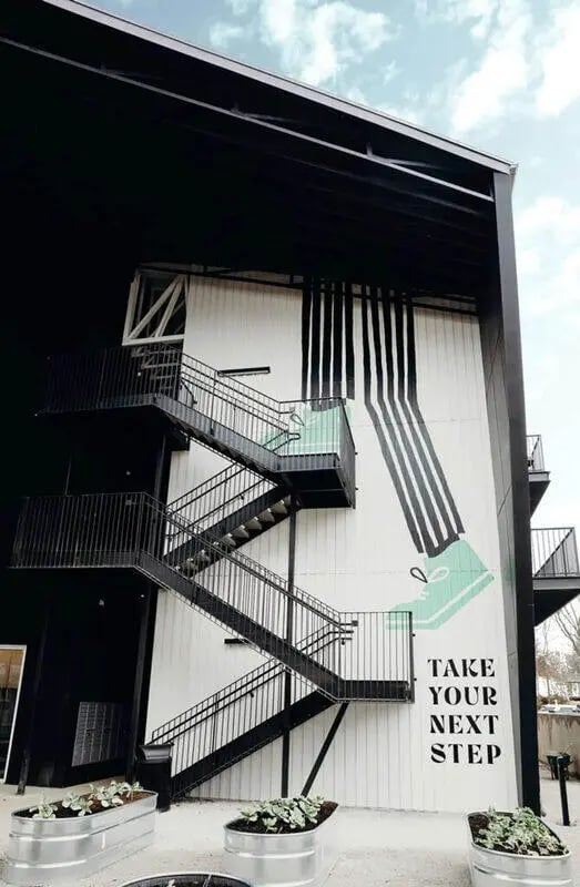 Exterior staircase with mural and planter boxes Exterior at Muse Bowling Green in Bowling Green Student Accommodation